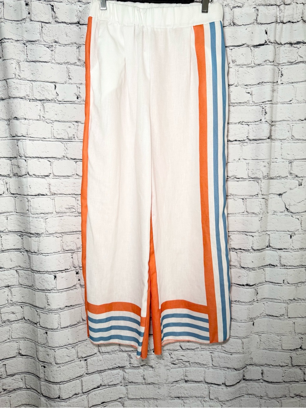 White,orange and blue pants. Size M